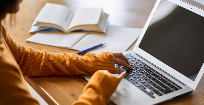 student studying and using laptop