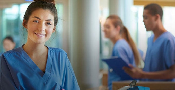 nursing students in blue scrubs